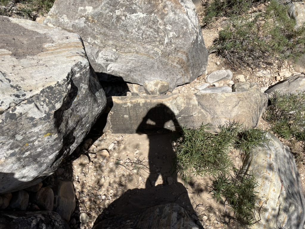 Shadow self-portrait on a boulder-strewn trail