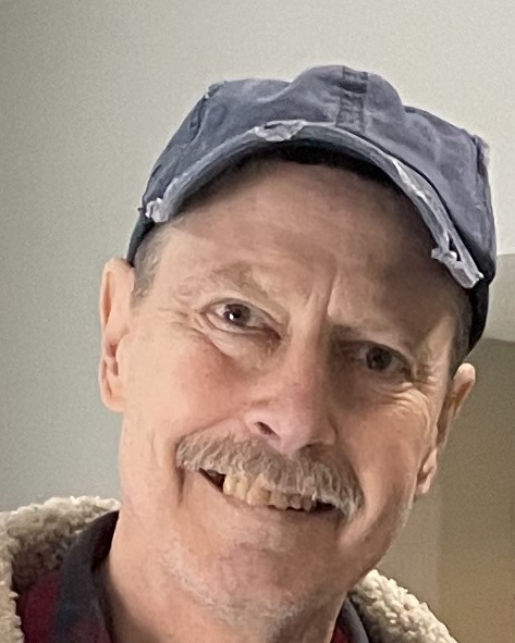 Rick Kirchner smiling in a blue cap and shearling-collared jacket, 2026
